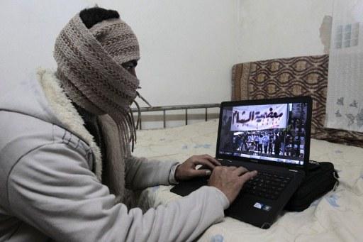 "Den arabiska våren" mobiliserades till stor del via internet. På bilden ses en syriansk flykting som tittar på nyheter från Syrien i sovrummet i huset han hyr från en jordanisk familj i Amman. (Foto: Khalil Mazraawi/ AFP)