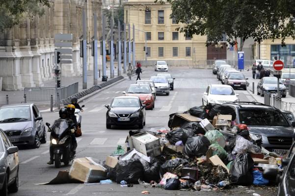 I Sverige har vi det rent på gatorna men det ser annorlunda ut i andra länder. I oktober strejkade sopåkarna i Marseille och då samlades en massa sopor och luktade illa. Bilens förare var nog inte glad att få sin bil bland alla sopor. (Foto: Anne-Christine Poujoulat / AFP)