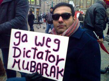 George Abraham i Nederländerna har en skylt där det står "Go Away Dictator Mubarak" vid ett möte i Amsterdam på tisdagen. Han tror inte att det finns någon återvändo nu efter flera dagar av protester med många offer i Egypten. (Foto: Jasper Fakkert/ Epoch Times)