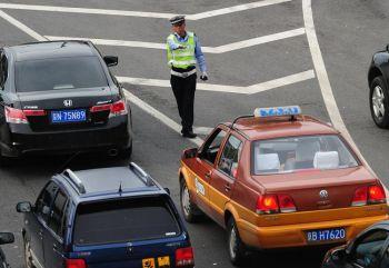 Trafikpolis i Peking. Partitjänstemän i Chongqing har börjat utbilda personer med höga akademiska titar till trafikpoliser. (Foto: Frederic J. Brown/Getty Images)