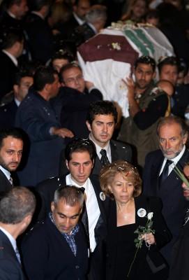 LIBANON, Bikfaya : Joyce Gemayel (höger), mor till den lönnmördade industriministern Pierre Gemayel, håller en blomma i handen när hon anländer tillsammans med sin yngre son Sami (mitten) till Gemayels begravningsceremonin i familjens hemstad Bikfaya i bergen nordost om Beirut den 23 november 2006. En sjö av deltagare i begravningen skanderar arga slagord mot Syriens libanesiska allierade när Beirut visade sin aktning för Gemayel, den siste mördade Damaskus opponenten. AFP PHOTO/HASSAN AMMAR