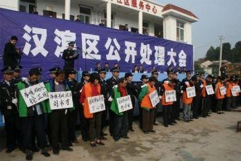 Lokala partifunktionärer i Shaanxiprovinsen höll ett offentligt förödmjukelsemöte som påminde om kulturrevolutionens dagar för att meddela domen mot 17 bybor som sökt sin rätt mot regimen för att de förlorat sin mark. De fick bära stora skyltar med domen och sina namn och hånades av församlade bybor. (Epoch Times arkivbilder)