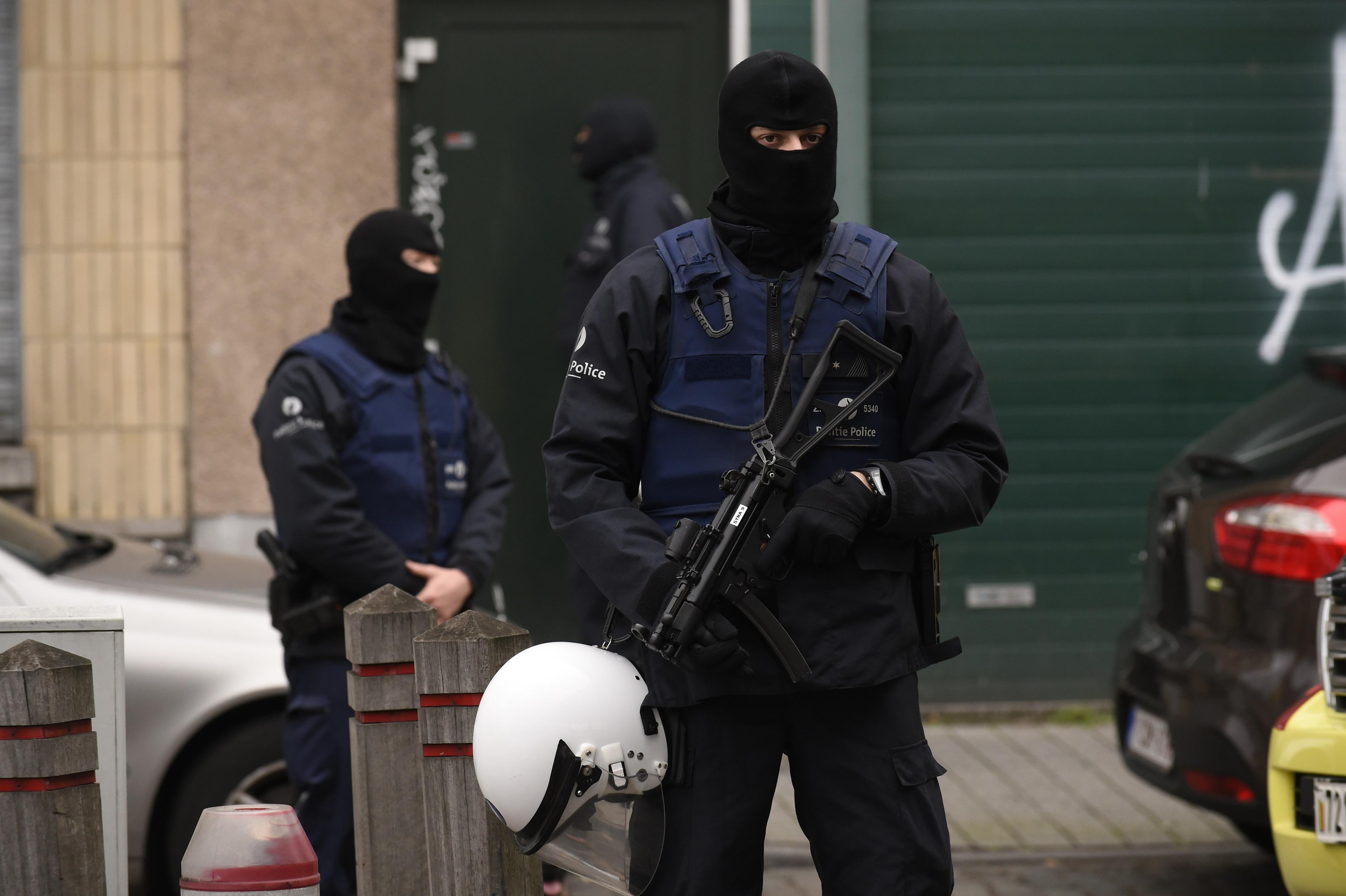 Belgiska poliser vaktar under en operation i Brysselförorten Molenbeek, där flera av de misstänkta för terrorattackerna i Paris tidigare bodde. (JOHN THYS/AFP/Getty Images)
