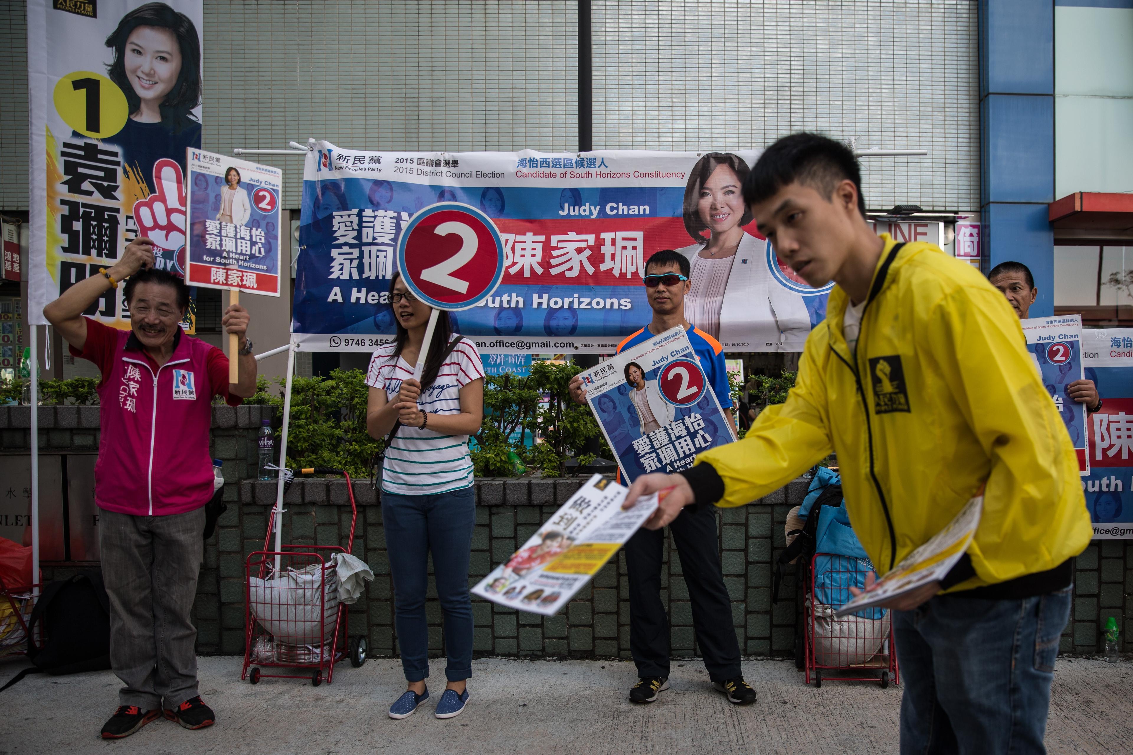 Valkampanjarbetare i Hongkong inför distriktsvalet den 22 november. I valet kom flera kandidater in som deltog i "paraplyprotesterna" för ökad demokrati i fjol. (ANTHONY WALLACE/AFP/Getty Images)
