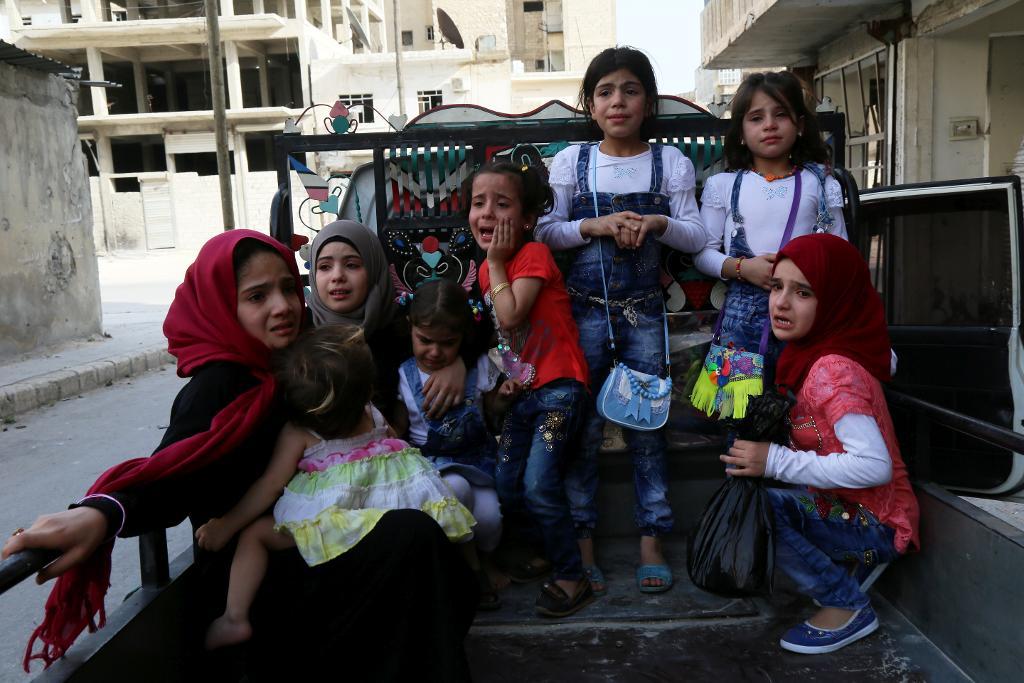 Barn väntar på transport efter en flygbombning i det rebellkontrollerade området Tariq al-Bab i den syriska staden Aleppo. (Foto: Khaled Khatib /TT)