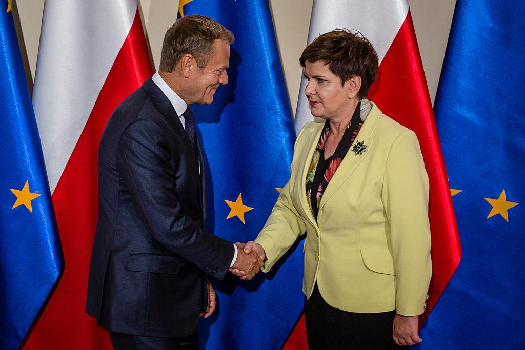 Donald Tusk skakar hand med den polska statsministern Beata Szydio. Båda är polsktalande men Polen finner sig inte i allt EU- säger, som lägre skatt till vissa företag. (Foto: Woitek Radwanski /AFP/Getty Images)