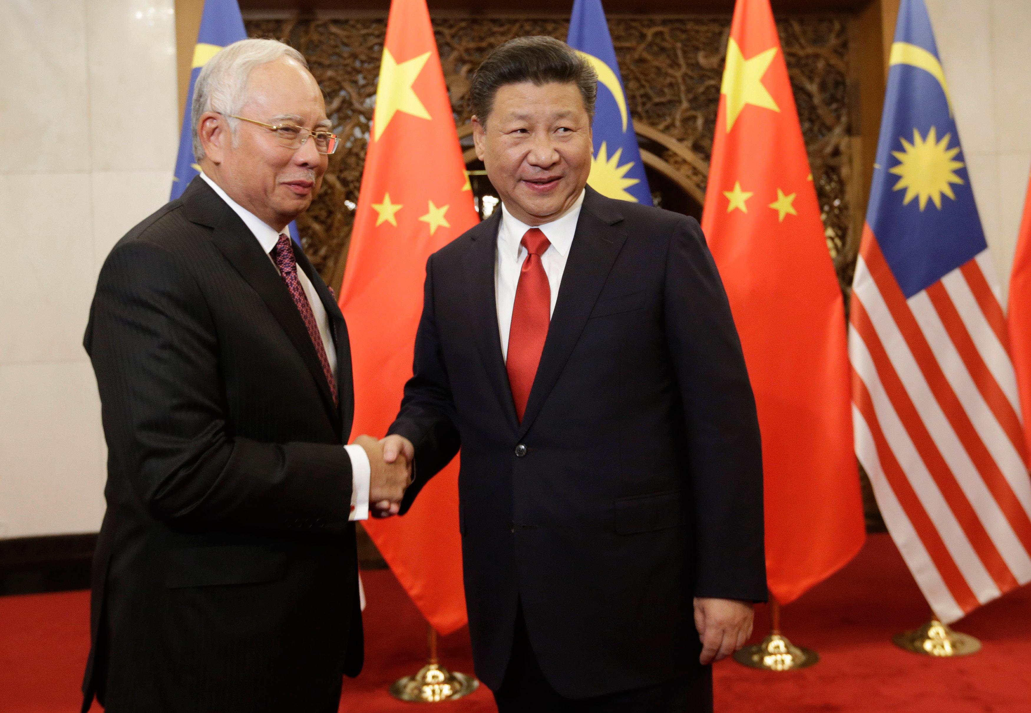 Malaysias premiärminister Najib Razak skakar hand med Kinas ledare Xi Jinping under deras möte i Peking den 3 november. (Foto: Jason Lee – Pool/Getty Images)