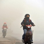 Skärmdump som visar motorcykelåkare med ansiktsmasker under en smoggig dag i Nanjing i södra Kina, den 7 december. (Netease/skärmdump/Epoch Times)