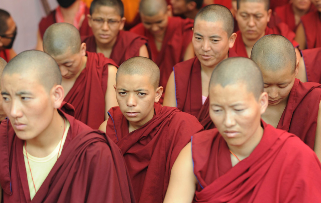 Tibetan Buddhist monks and nuns participate in a sit-in solidarity rally against China's rule on Tibet, in New Delhi on October 18, 2011. Hundreds of Tibetans in-exile urged Chinese authorities to respect the fundamental rights of Tibetans to freely practice their religion, following several cases of self-immolation by Tibetans against Chinese rule in the Himalayan region. AFP PHOTO/RAVEENDRAN (Photo credit should read RAVEENDRAN/AFP/Getty Images)