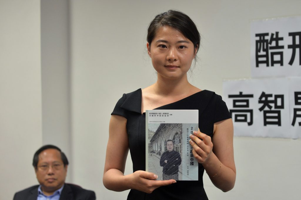 Grace Geng (R), daughter of Gao Zhisheng, a renowned human rights lawyer in China, holds her father's book "A Human Rights Lawyer under Torture the auto narratives of Gao Zhisheng", as lawmaker Albert Ho (L) looks on during a press conference at the Legislative Council Complex in Hong Kong on June 14, 2016. A leading dissident lawyer in China is prepared to face the consequences over his new book predicting the possible collapse of the ruling Communist Party, his tearful daughter said June 14. Gao Zhisheng has been under house arrest since 2014 after serving a three-year prison term on subversion-related charges -- a sentence which sparked an international outcry. / AFP / ANTHONY WALLACE (Photo credit should read ANTHONY WALLACE/AFP/Getty Images)