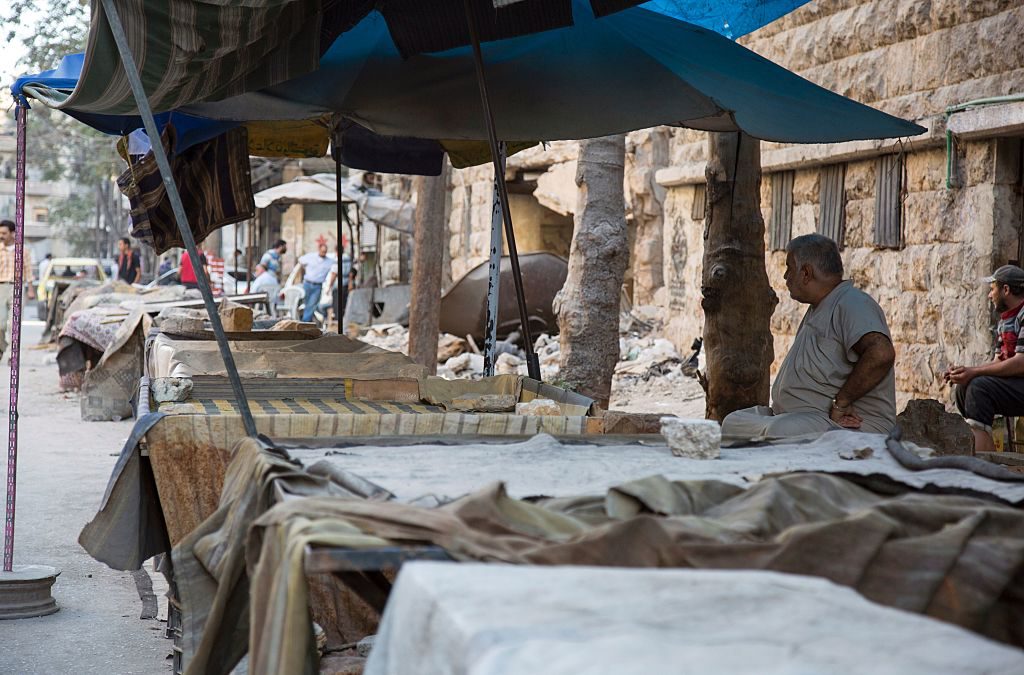 En man står vid det som tidigare var en marknadsplats. Nu har ståndet inga varor och många är borta, (Foto: Kram Al-Masri /AFP/Getty Images)