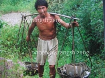 Före detta doktoranden Wang Qingsong bär på förnödenheter. (Foto: Tang Shizeng)