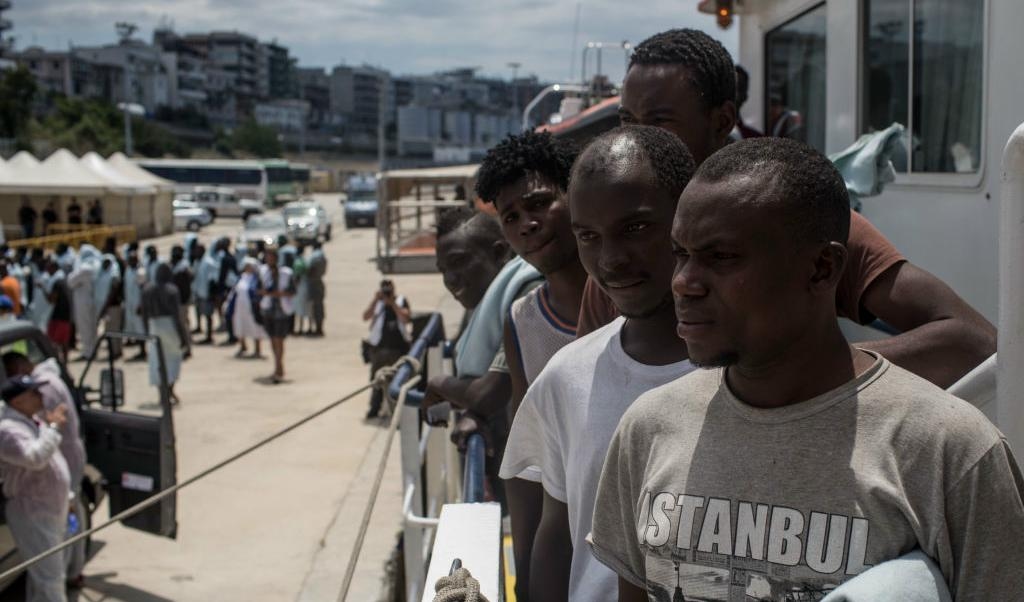 
Flyktingar och migranter som räddats ute på Medelhavet väntar på att få gå i land i Italien. Foto: Chris McGrath/Getty Images                                            
