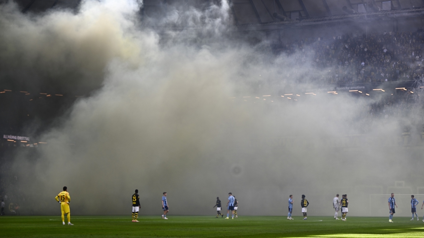 Brandpersonal har lyckats släcka eldhärden på ståplatsläktaren och enligt AIK:s säkerhetschef Henrik Koch skadades ingen person. Foto: Anders Wiklund/TT