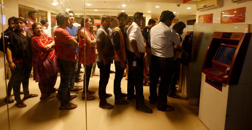 Indier i staden Ahmedabad köar utanför en bankomat för att få tag på de nya 2 000-rupiesedlarna, efter beskedet att 1 000- och 500-rupiesedlar inte längre får användas. (Foto: Ajit Solanki/AP/TT)