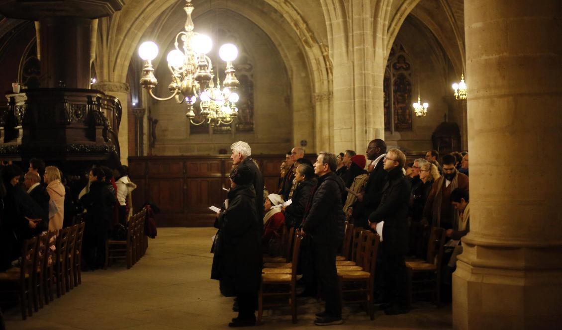 Mässbesökare i Saint-Germain l'Auxerrois under tisdagskvällen. Foto: Thibault Camus/AP/TT