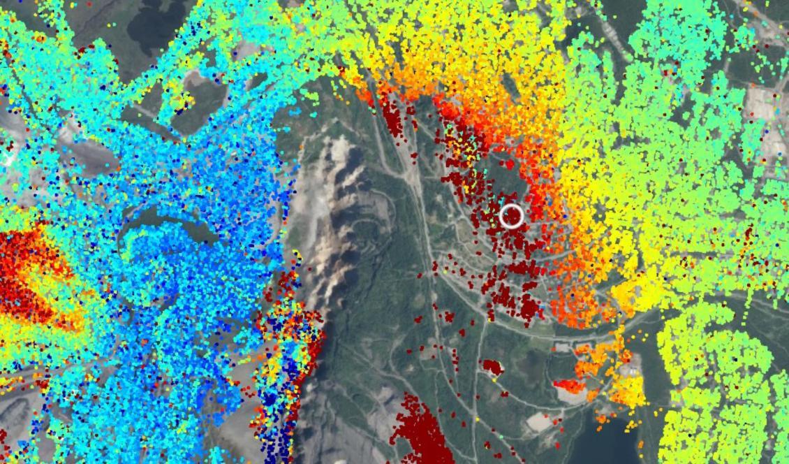 Bilden visar Kiruna och Hjalmar Lundbohmsskolan i datatjänsten Insar. De olika punkterna visar rörelser i marken. Röd färg indikerar en rörelse bort från satelliten mot området för gruvdrift. Det är denna rörelse som gör att byggnaderna spricker. Foto: Insar/Rymdstyrelsen