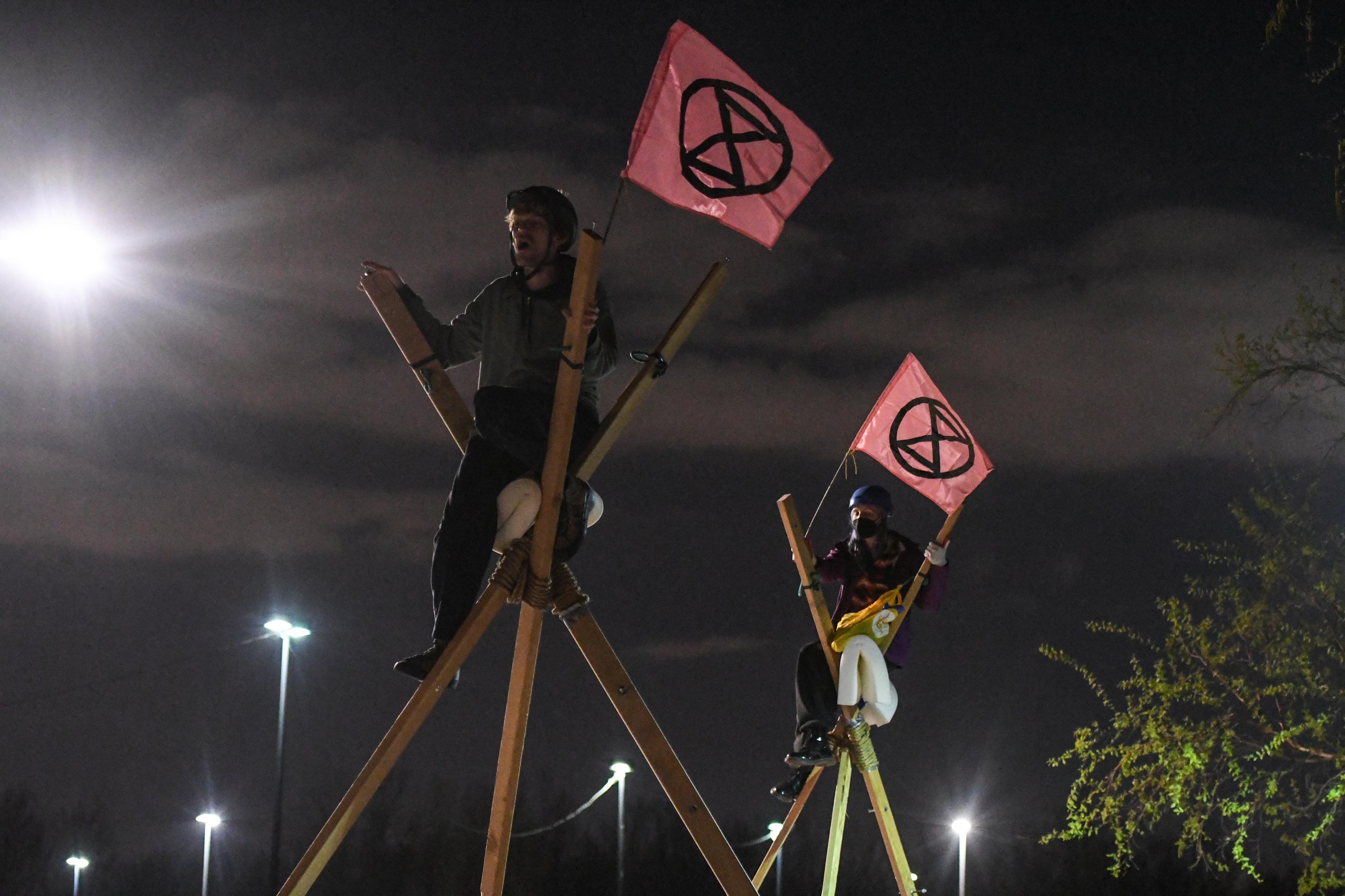 På bilden ses personer från klimatnätverket Extinction Rebellion göra en aktion framför New York Times tryckeri i stadsdelen Flushing i Queens i New York den 21 april 2022. Foto: Stephanie Keith/Getty Images