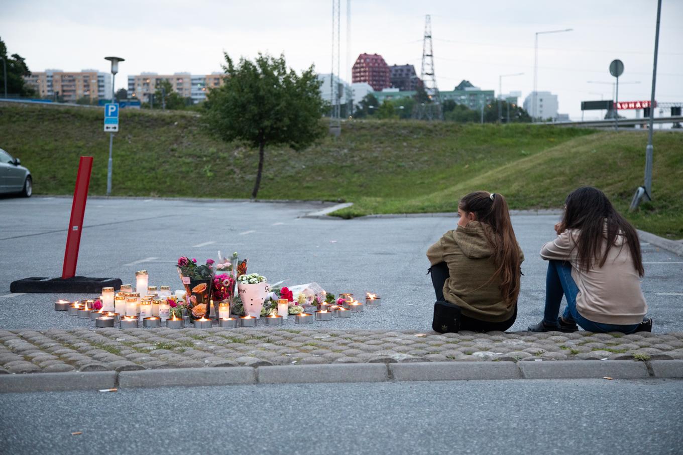 Blommor och ljus på platsen där tolvåriga Adriana sköts till döds i Norsborg den 2 augusti 2020. Arkivbild. Foto: Ali Lorestani/TT