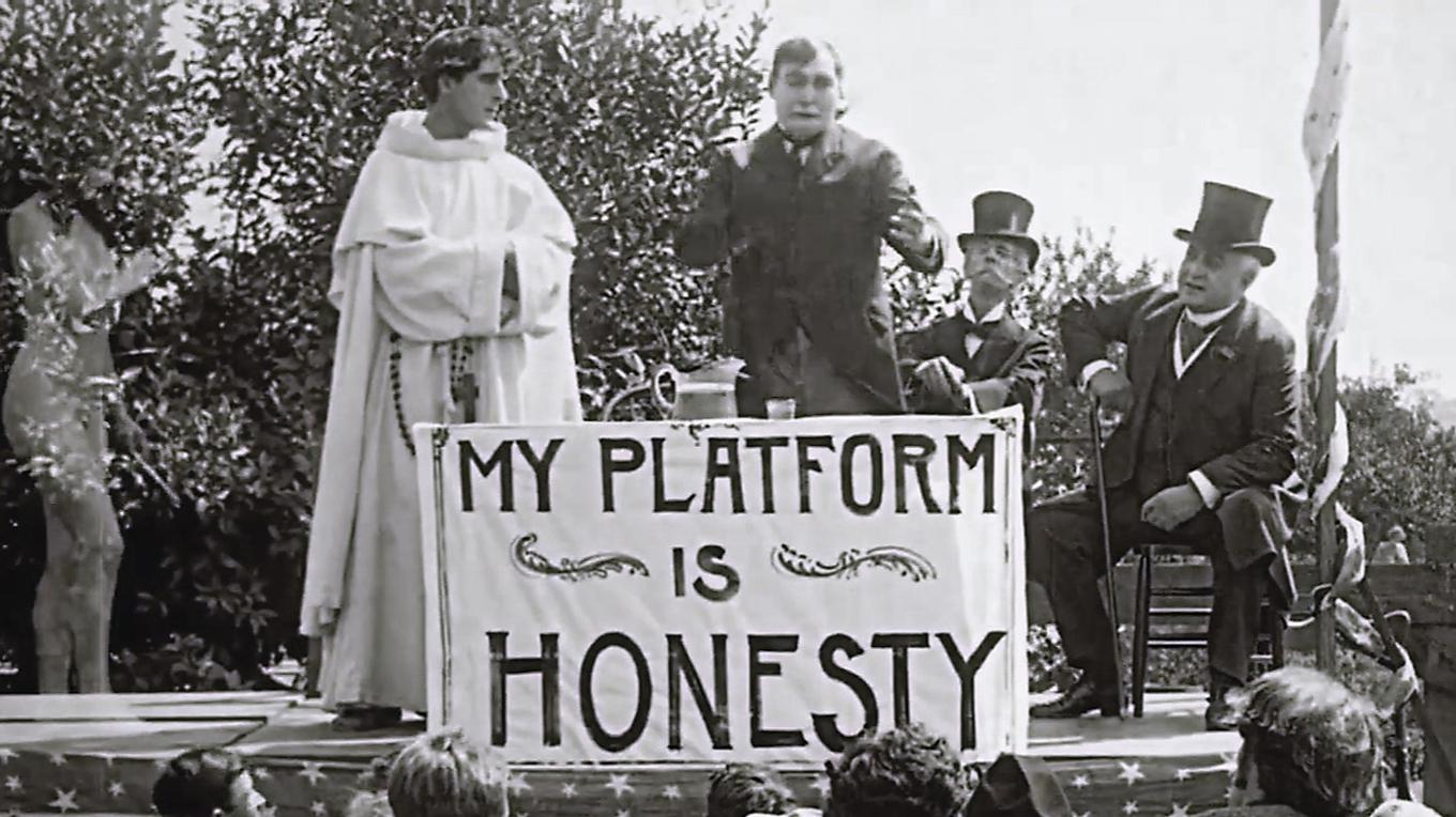 I hörnet står den nakna sanningen – resten av bilden upptas av människorna. Foto: Public Domain