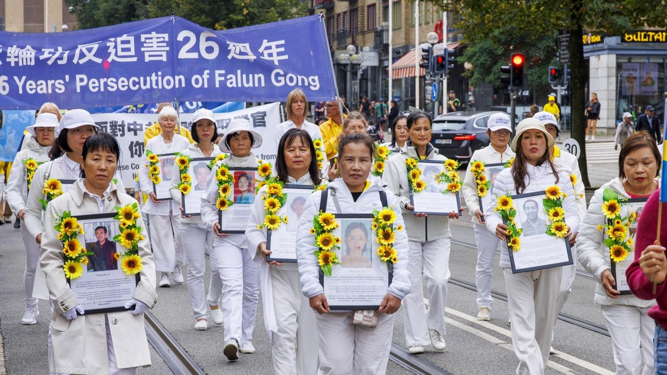 I paraden visades fotografier på de som dött till följd av förföljelsen i Kina.   Foto: Anders Eriksson