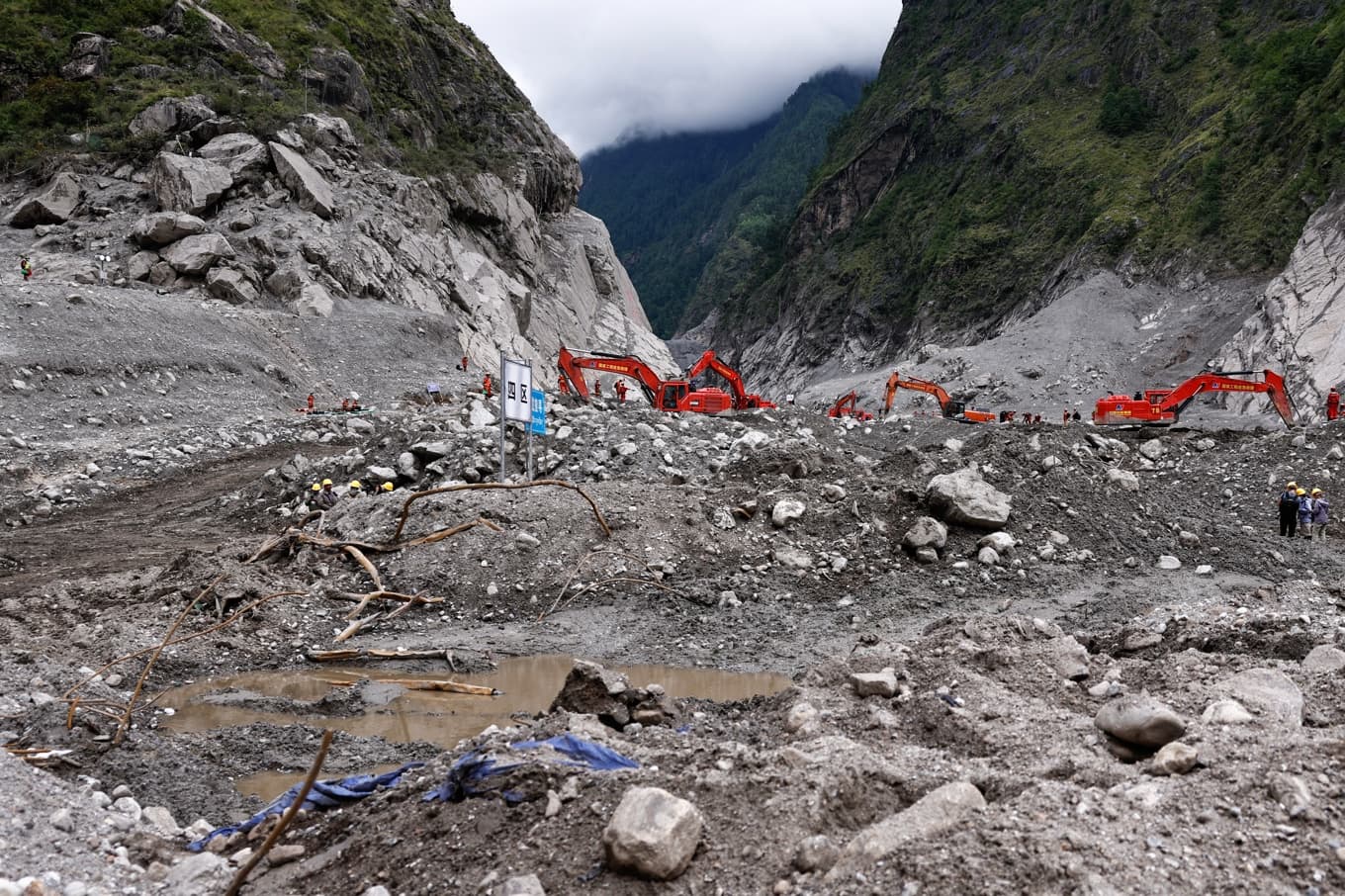 Räddningsarbetare i Tibet söker efter överlevare i det drabbade området Gyirong Port. Bilden är tagen i samband med en av kinesiska myndigheter arrangerad rundtur för journalister. Foto: Tingshu Wang/AP/TT