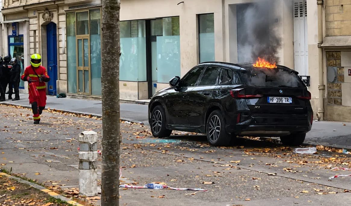 Upploppsmakare har satt eld på en bil på  Boulevard des Invalides i Paris den 13 oktober. Foto: Etienne Fauchaire