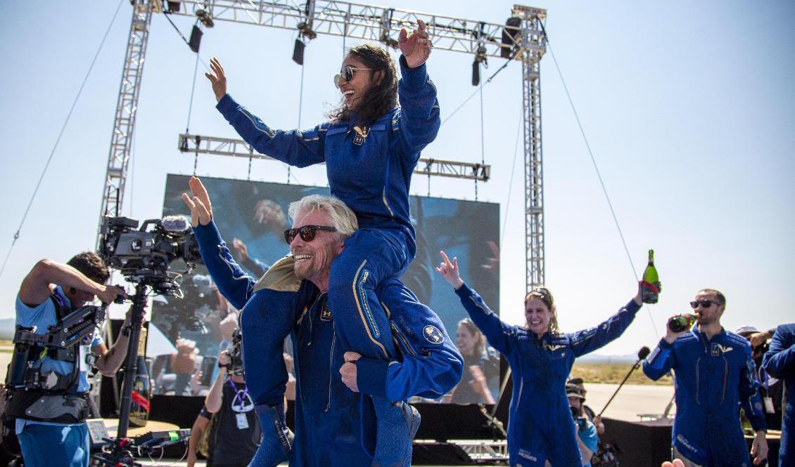 Virgin Galactics grundare Richard Branson, med besättningsmedlemmen Sirisha Bandla på axlarna, firar triumfen efter att ha landat i New Mexico. Foto: Andres Leighton/AP/TT