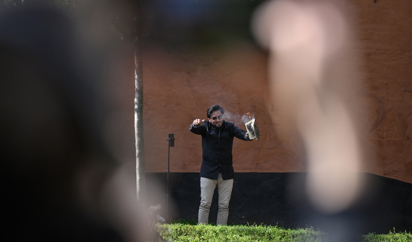 Salwan Momika bränner en koran vid Medborgarplatsen i närheten av Stockholms moské. Foto: Henrik Montgomery/TT