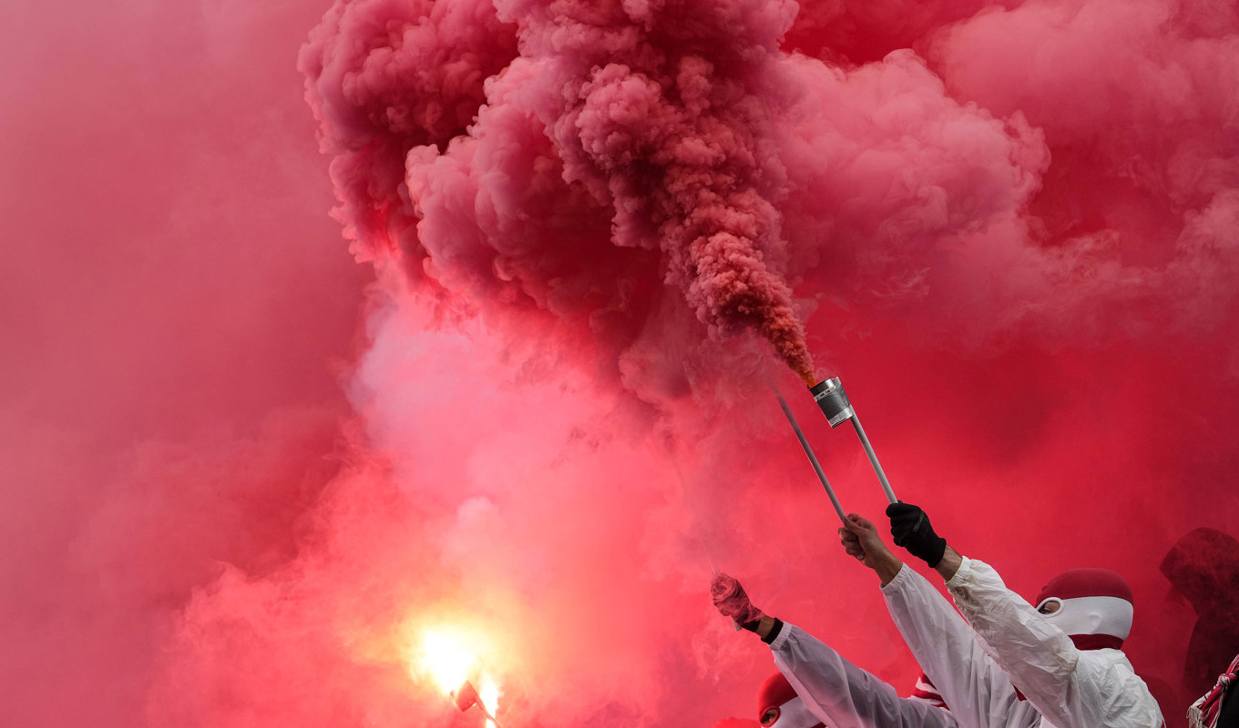 Maskerade Köln-supportar bränner pyroteknik. Nu drabbas klubben av rekordböter. Arkivbild. Foto: Martin Meissner/AP/TT