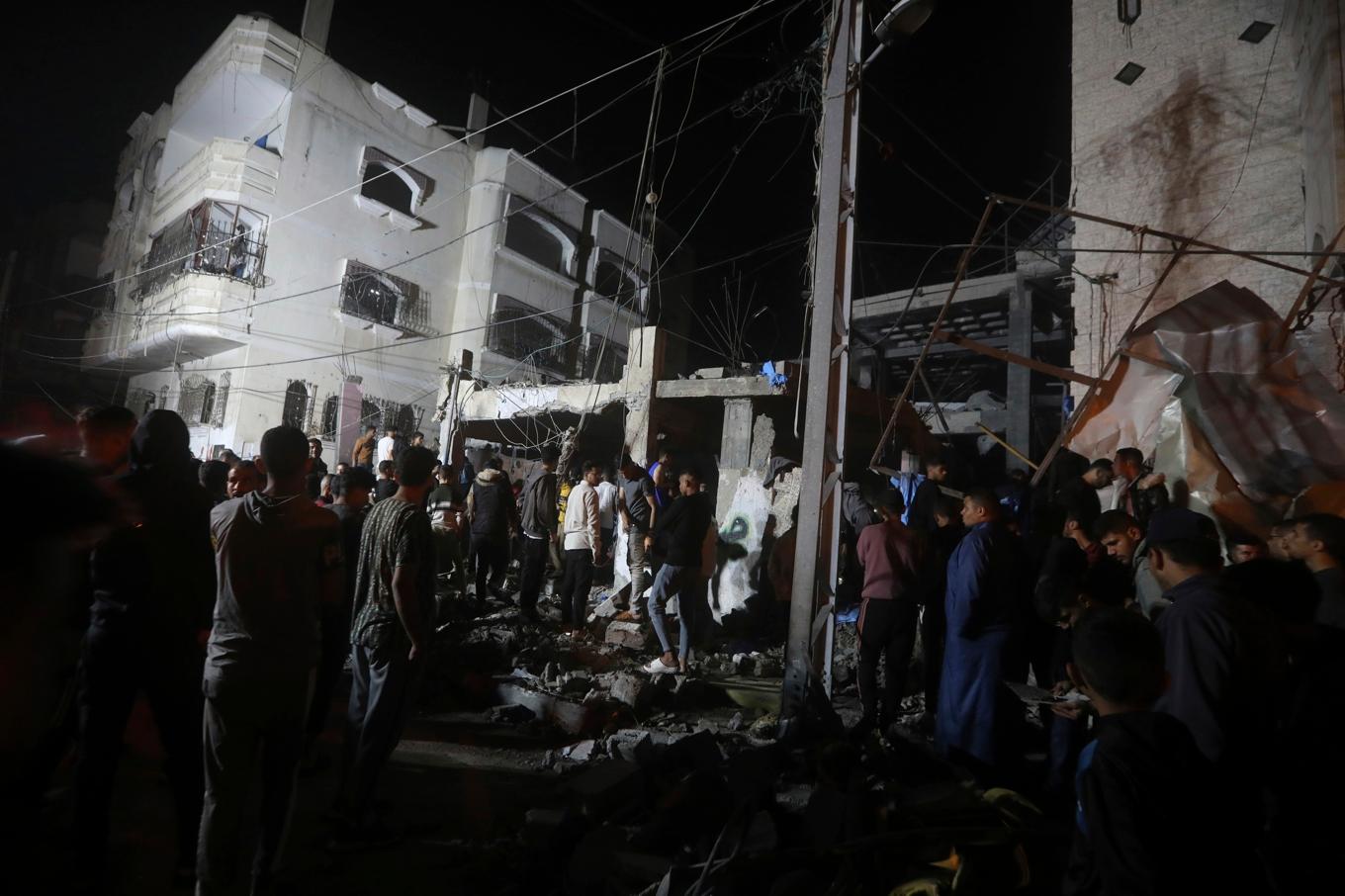 Palestinier vid en förstörd byggnad efter en israelisk attack mot ett flyktingläger i Rafah i Gaza. Arkivbild. Foto: Ismael Abu Dayyah/AP/TT