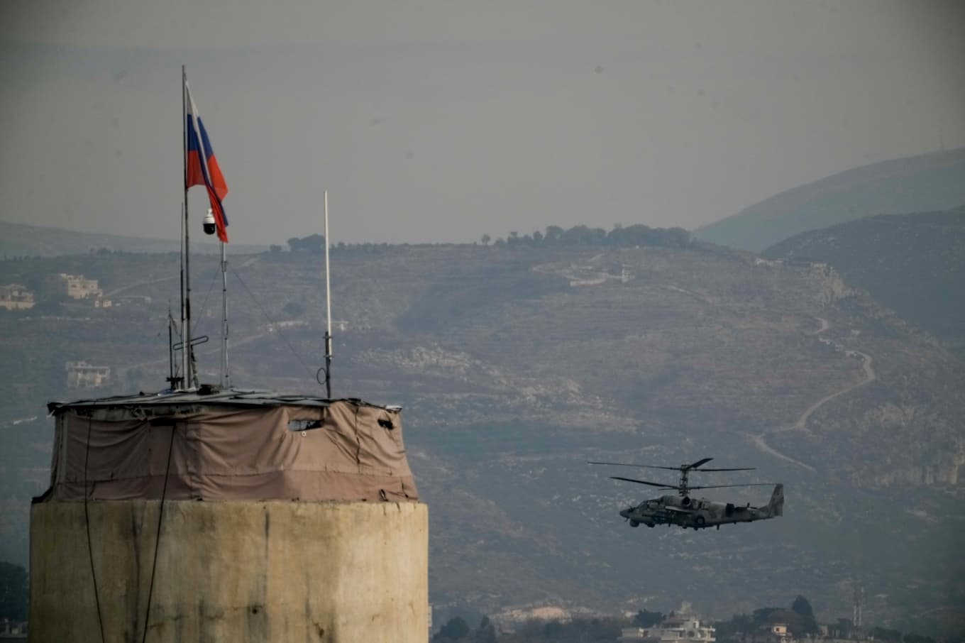 En rysk helikopter flyger över flygbasen Khmeimim, sydost om staden Lakakia i västra Syrien. Arkivbild. Foto: Leo Correa/AP/TT