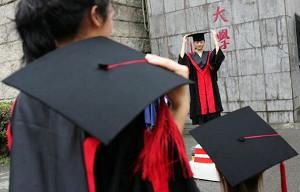 Avgångsstudenter poserar vid en examensceremoni på Renminuniversitet i Peking. Enligt en undersökning är nästan 1,8 miljoner studenter i Kina så fattiga att de inte kan betala universitetsavgifterna. (Foto: China Photos/Getty Images)