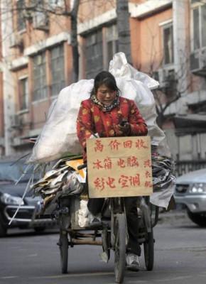 En kvinna på en trehjuling lastad med material för återvinning i Peking. (Liu Jin/AFP/Getty Images)
