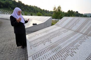 Hatidza Mehmedovic, en bosnisk muslimsk kvinna som överlevde grymheterna i Srebrenica år 1995, ber framför minnesmuren med namnen på offren i den bosnisk-serbiska offensiven i juli 1995, den 26 maj 2011 i Potocari nära Srebrenica (Foto: Elvis Barukcic/AFP/Getty Images) 