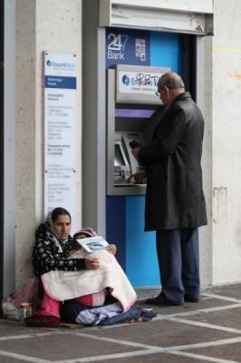 En grekisk man tar ut pengar från en bankomat i Aten, Grekland. EU-tjänstemän medger att de gör beredskapsplaner för att begränsa bankomatuttagen i händelse av att Grekland lämnar euroområdet. (Foto: Oli Scarff / Getty Images)