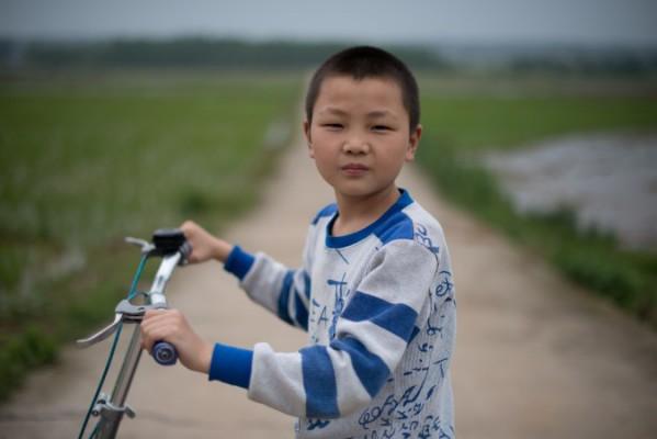 Diskrimineringen av migrantarbetare drabbar många barn, som denna pojke i byn Zhuangshuzui i Hunanprovinsen på den kinesiska landsbygden hårt. (Foton: Ed Jones/AFP/Getty Images)"
