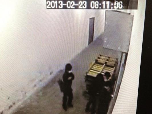 En skärmdump från en övervakningskamera visar tre maskerade män som försöker bryta upp dörren till Epoch Times tryckeri i Hongkong, den 23 februari. De lyckades dock inte, och nu undersöker polisen i Hongkong saken. (Foto: Epoch Times)