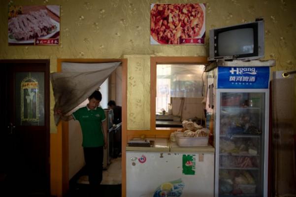 En kypare kommer ut från köket i en halal-restaurang i Jiayuguan, Gansuprovinsen i Kina den 14 maj 2013. (Foto: AFP/Getty Images/Ed Jones)