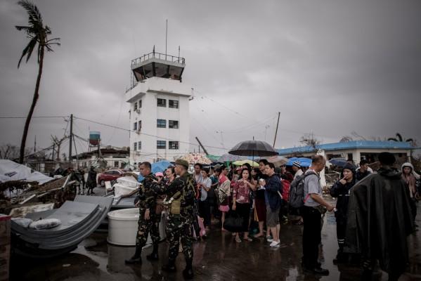 Tyfonens offer väntar på att bli evakuerade på Taclobans flygfält på ön Leyte den 12 november 2013 efter att supertyfonen Haiyan rasat över Filippinerna. (Foto: AFP/Philippe Lopez)