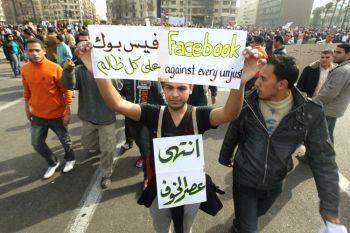 Ung egyptier håller upp en skylt som prisar Facebook, under en demonstration för demokrati på Tahrirtorget i Kairo i februari. Arbetslösheten bland teknikkunniga utbildade ungdomar i Egypten och i andra delar av regionen utgjorde en del av det bränsle som fick Arabvärlden att antändas. (Foto: Khaled Desouki/AFP/Getty Images) 