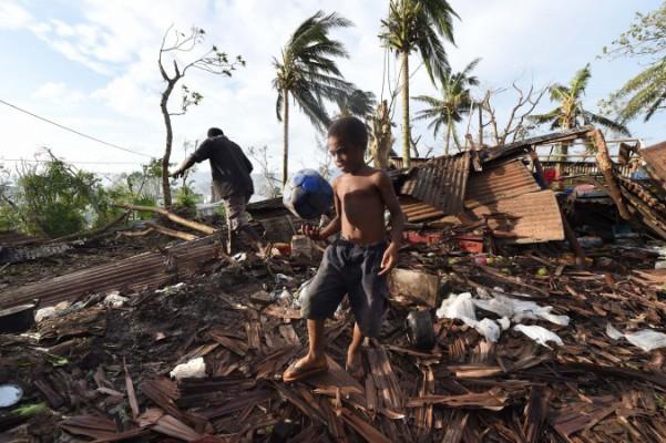 En man och hans son undersöker det som före cyklonen Pam var deras hem i Port Vila den 16 mars 2015. Cyklonen Pam slog till mot ögruppen Vanuatu i södra Stilla havet den 14 mars. Biståndsorganisationer säger att det kan vara den värsta katastrofen någonsin i området. (Foto: Dave Hunt-Pool /Getty Image) 