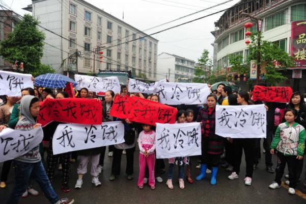 Demonstranter i Baoxinghäradet protesterade den 23 april mot bristen på nödhjälpsutrustning efter jordbävningen. På deras plakat står "jag fryser och är hungrig". Kommunistpartiet har hindrat utomstående volontärer från att hjälpa till med räddningsarbetet och tackat nej till utrustning. (Foto: AFP/Getty Images)