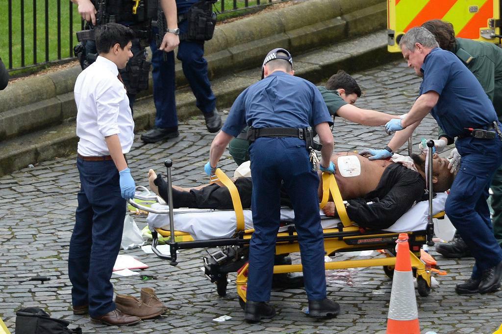 Khalid Masood vårdas av ambulanspersonal efter att han skjutits av polis vid parlamentsområdet. Foto:
Stefan Rousseau/AP/TT