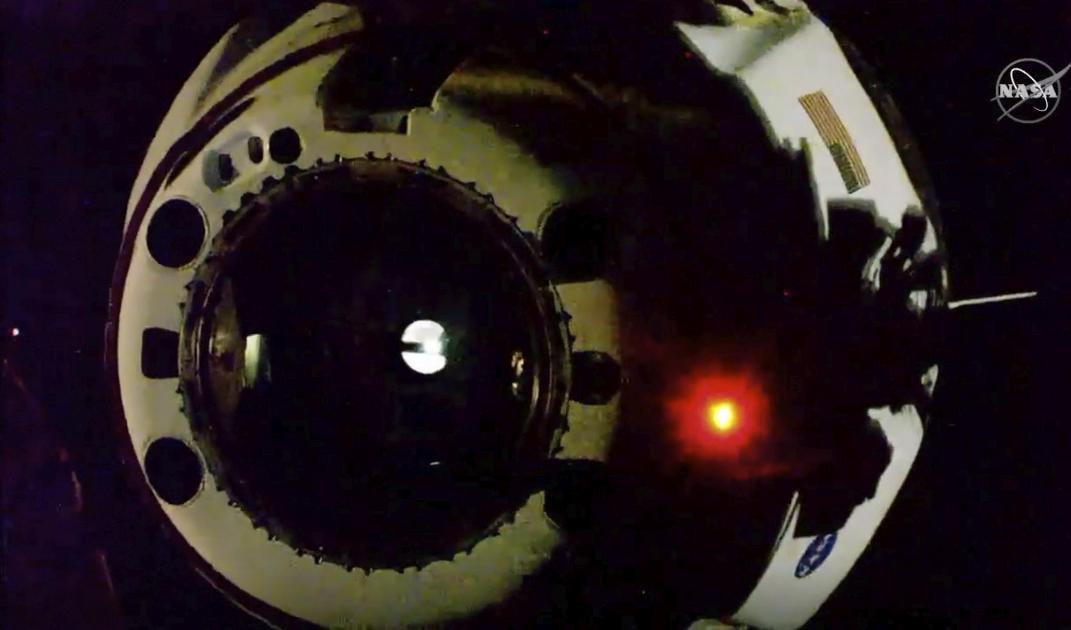 Space X rymdkapsel har kopplats loss från rymdstationen ISS och är på väg mot jorden. Foto: NASA via AP/TT