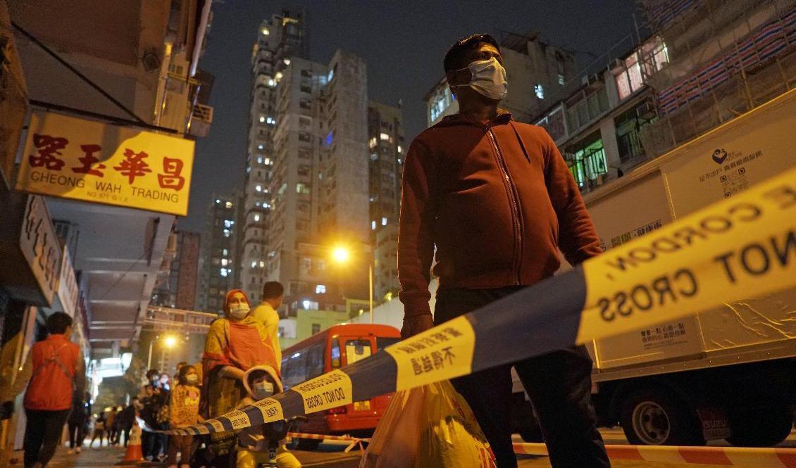 Hongkongbor köade under fredagskvällen vid tillfälliga testanläggningar inför lördagens nedstängning. Foto: Kin Cheung/AP/TT