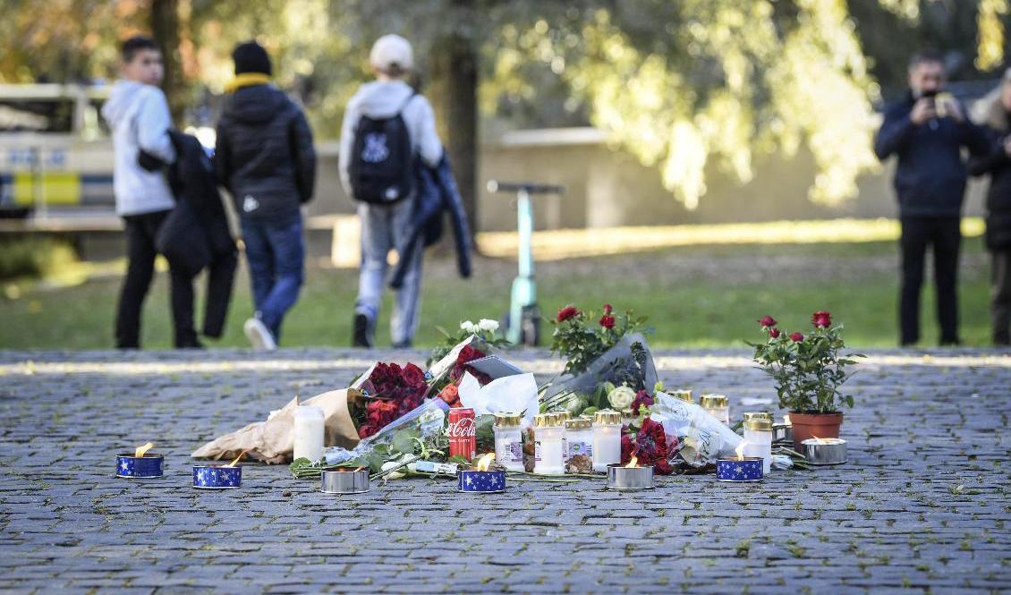 Tända ljus och blommor i närheten av platsen där artisten Einár sköts till döds i Hammarby sjöstad på torsdagskvällen. Foto: Fredrik Sandberg/TT