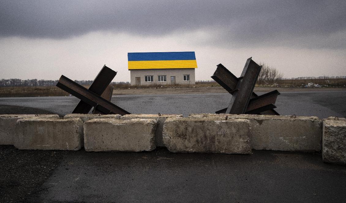 Fordonshinder och ett hus med Ukrainas flagga målad på taket utanför Kiev. Arkivbild. Foto: Rodrigo Abd/AP/TT
