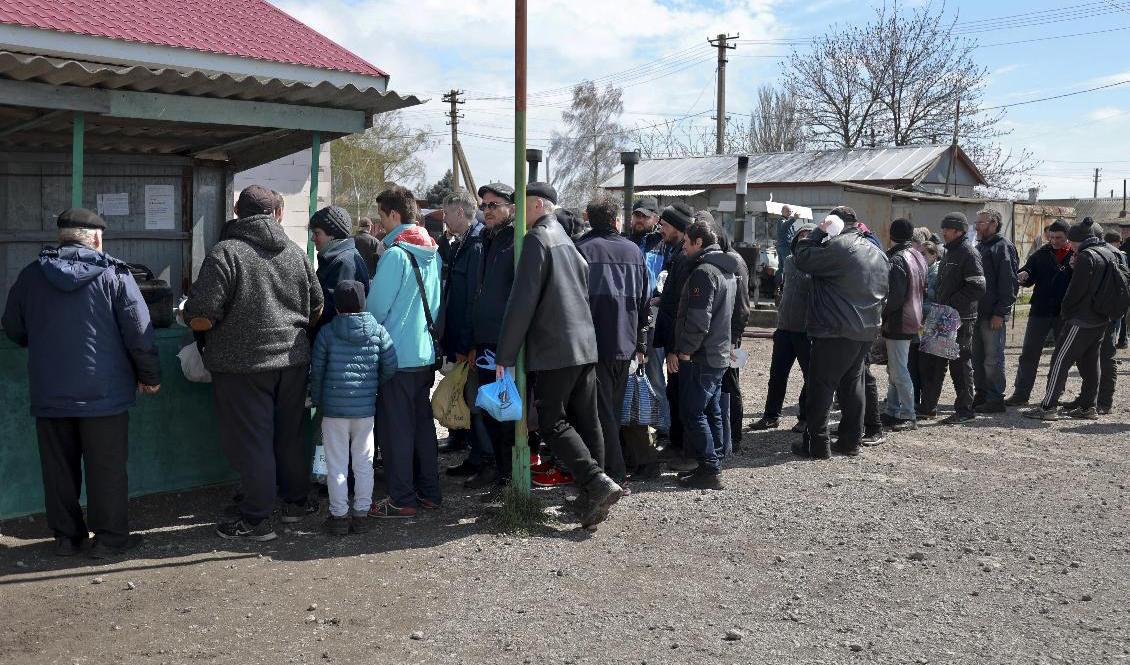 Människor köar för mat i byn Bezimenne i Donetskregionen i östra Ukraina. Foto: Alexei Alexandrov/AP/TT