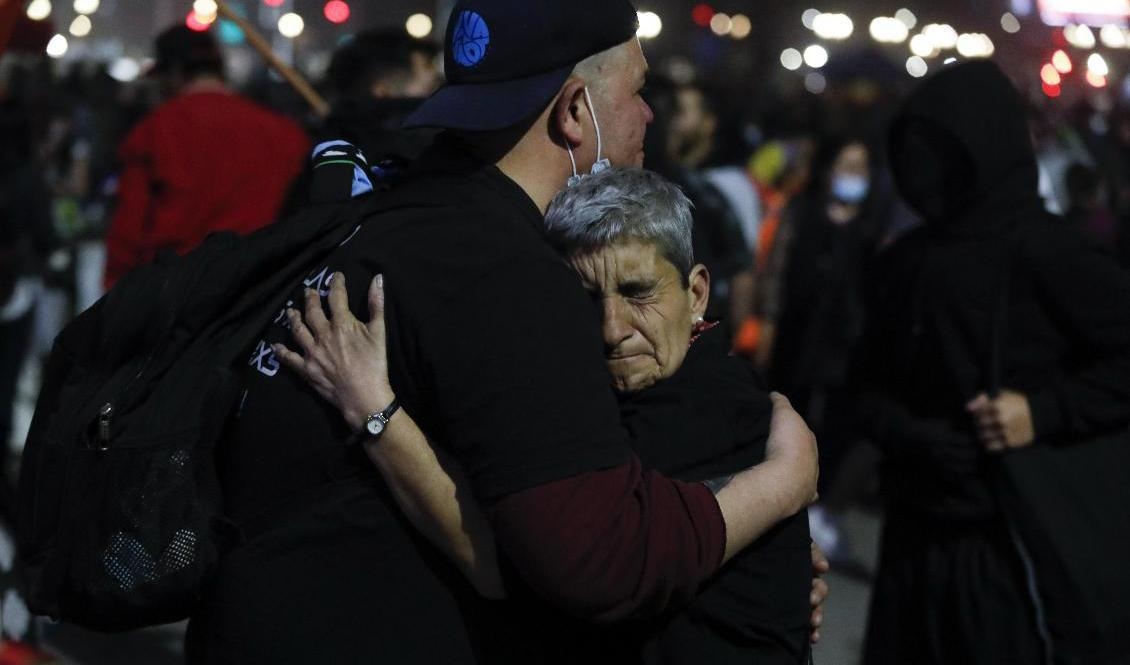 Anhängare till ja-sidan kramar om varandra när de lyssnar till uppdateringar om folkomröstningen. Foto: Matias Basualdo/AP/TT